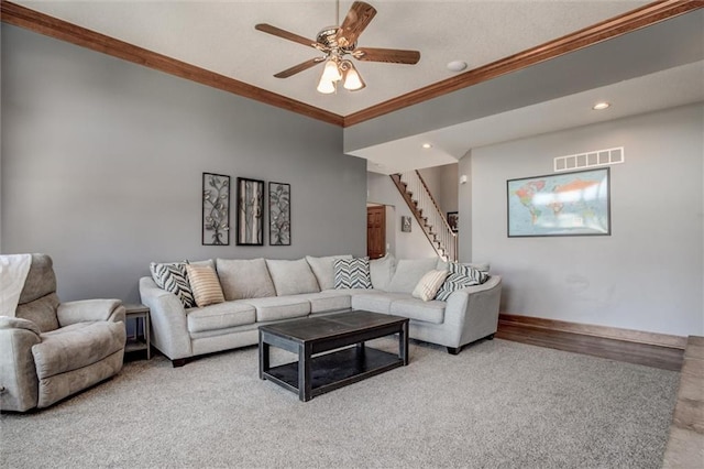 living room with ornamental molding, wood-type flooring, and ceiling fan