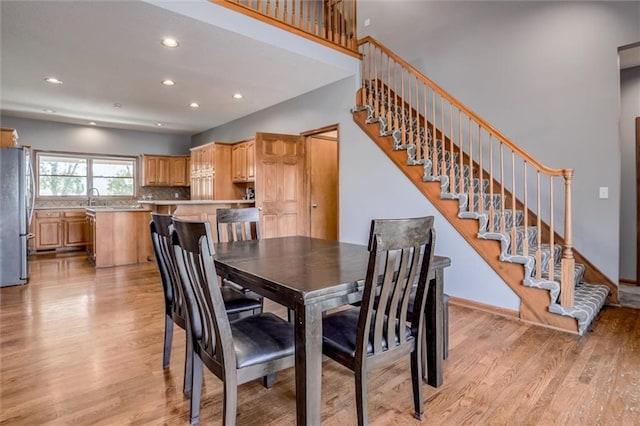 dining space with light hardwood / wood-style flooring and sink