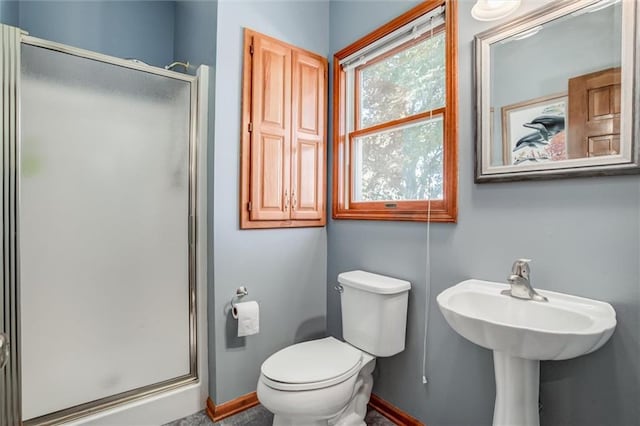 bathroom with toilet and an enclosed shower