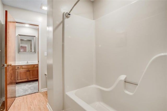 bathroom with vanity, bathtub / shower combination, and wood-type flooring