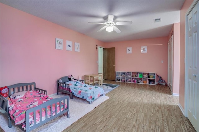 bedroom with a closet, ceiling fan, and hardwood / wood-style floors