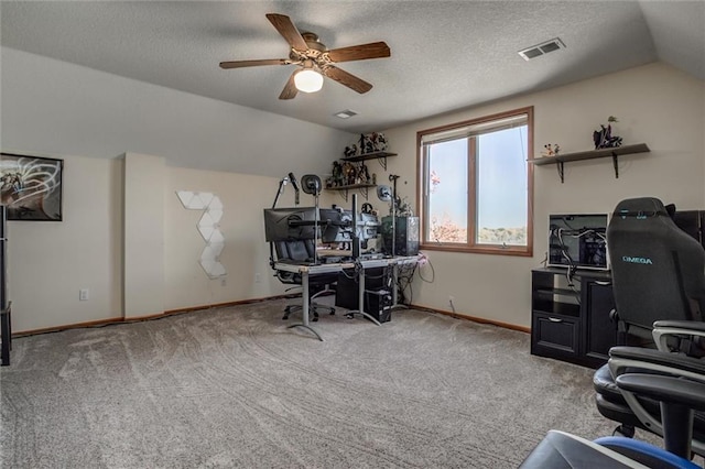 office area featuring ceiling fan, light carpet, a textured ceiling, and vaulted ceiling