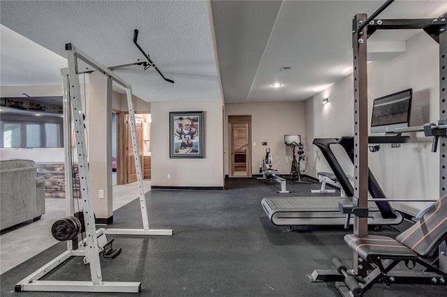 exercise room with a textured ceiling