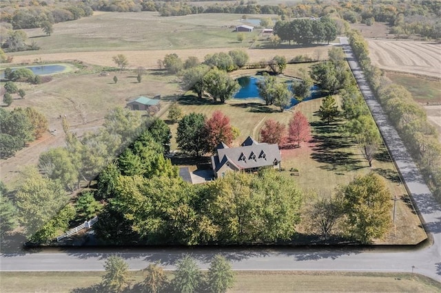 birds eye view of property featuring a water view and a rural view