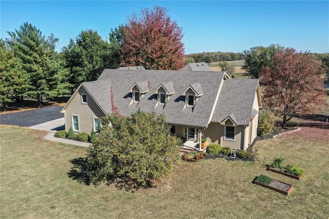 cape cod house with a front yard