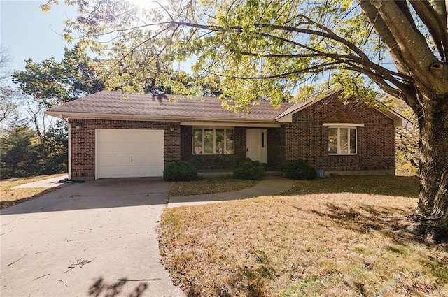 ranch-style house featuring a garage and a front lawn