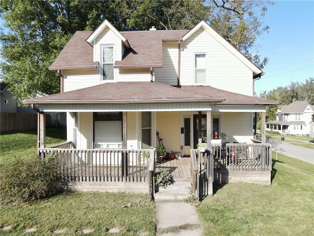 farmhouse inspired home featuring a porch and a front lawn