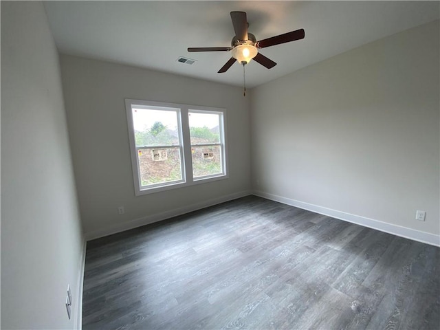 spare room with ceiling fan and dark wood-type flooring