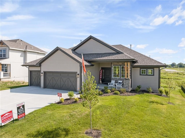 view of front of home featuring a front lawn and a garage