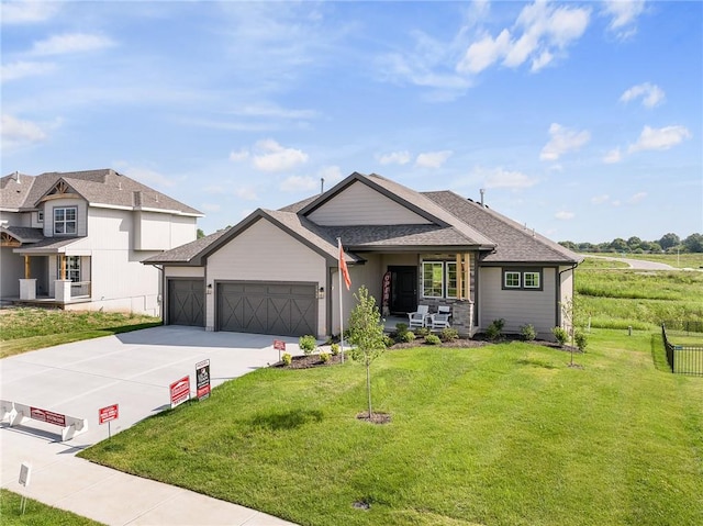 view of front of house with a front yard and a garage