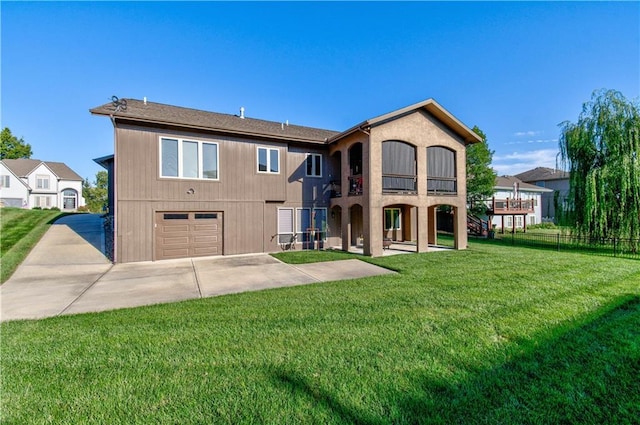 back of property featuring a balcony, a yard, and a garage