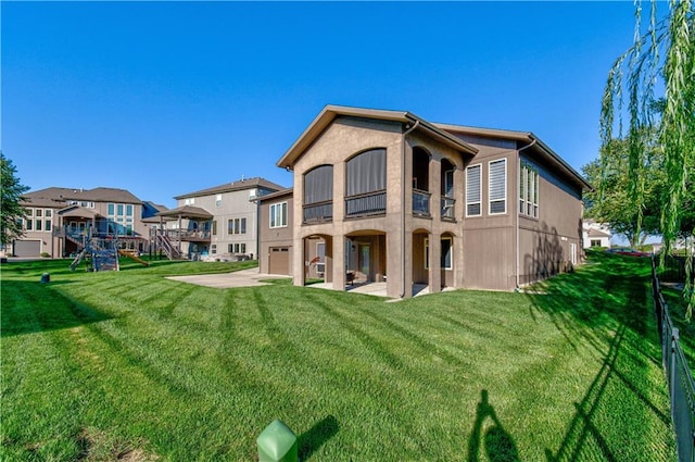 back of house with a playground, a lawn, and a balcony