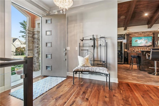 foyer with a healthy amount of sunlight, hardwood / wood-style flooring, and wooden ceiling