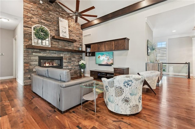 living room with beam ceiling, high vaulted ceiling, dark hardwood / wood-style flooring, and a fireplace