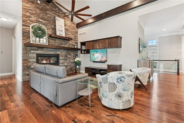 4500 SW Aft Dr, Lees Summit, MO 64082 - living area featuring visible vents, baseboards, wood finished floors, ceiling fan, and a stone fireplace