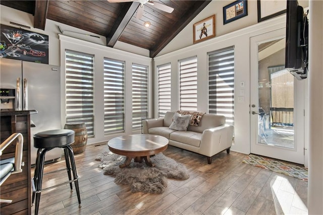 living room featuring ceiling fan, hardwood / wood-style flooring, wooden ceiling, and vaulted ceiling with beams