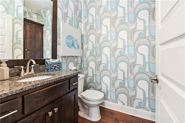 bathroom featuring vanity, toilet, wood-type flooring, and a shower with curtain