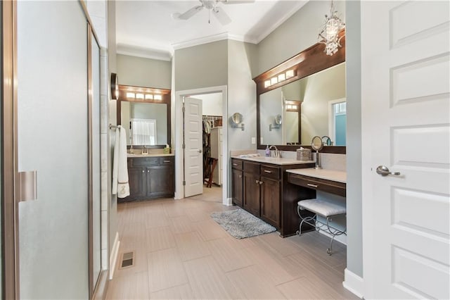 bathroom featuring vanity, ceiling fan, ornamental molding, and an enclosed shower