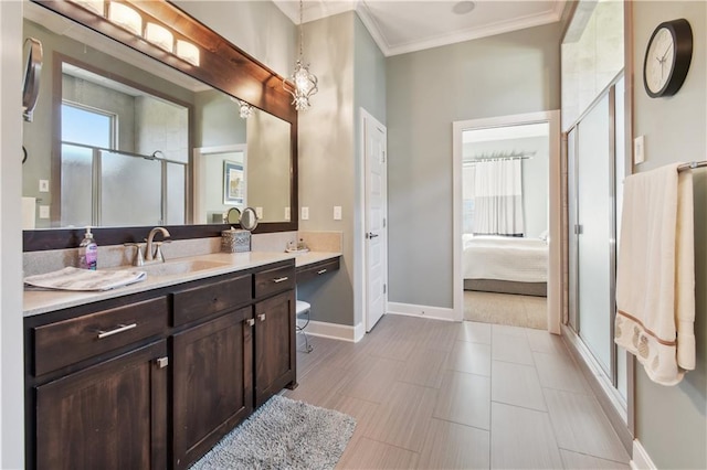 bathroom featuring vanity, an enclosed shower, and ornamental molding