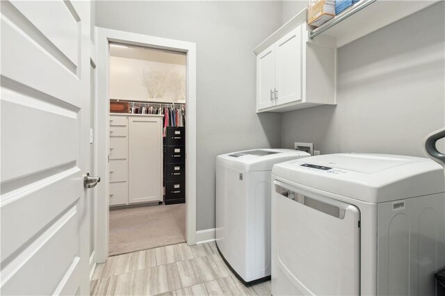 4500 SW Aft Dr, Lees Summit, MO 64082 - washroom featuring washer and dryer, light carpet, and cabinet space