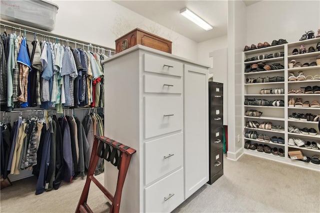 walk in closet featuring light carpet