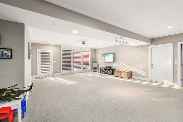 unfurnished living room with ceiling fan, carpet flooring, and ornamental molding