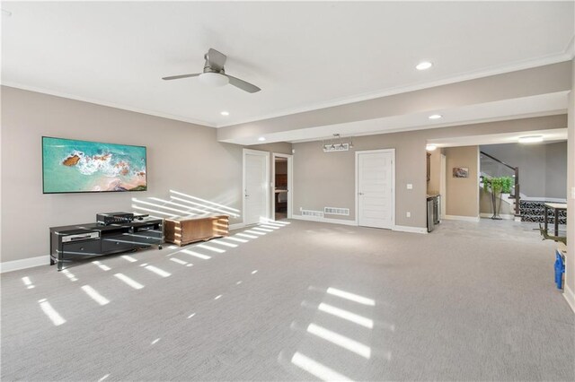 living room featuring ornamental molding, light colored carpet, and ceiling fan