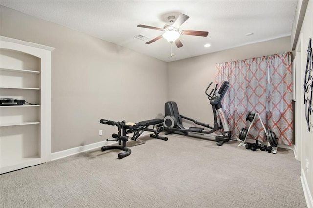 workout room with ceiling fan and carpet flooring