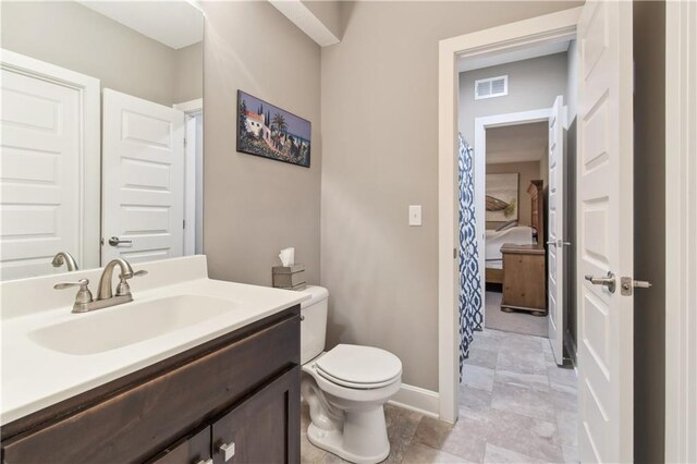 bathroom with vanity and toilet