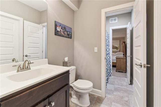 4500 SW Aft Dr, Lees Summit, MO 64082 - bathroom with toilet, vanity, visible vents, and baseboards
