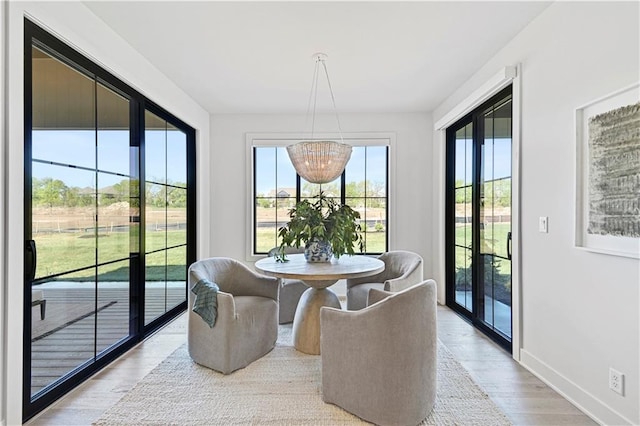 sunroom featuring an inviting chandelier