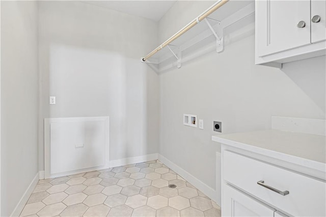 washroom featuring cabinets, hookup for a washing machine, light tile patterned floors, and electric dryer hookup