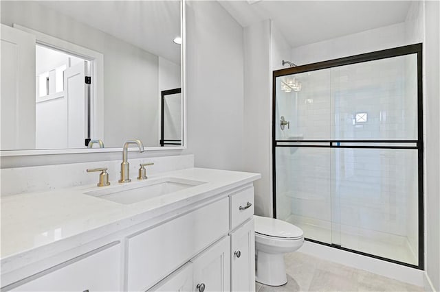 bathroom with tile patterned flooring, vanity, toilet, and a shower with door