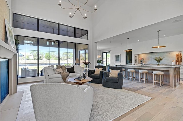 17004 Parkhill St, Overland Park, KS 66221 - living area with a high ceiling, light wood finished floors, and a chandelier