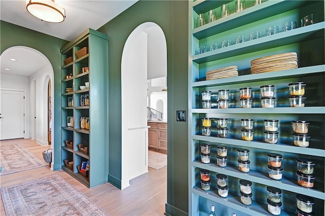 17004 Parkhill St, Overland Park, KS 66221 - hallway with arched walkways, wood finished floors, and baseboards