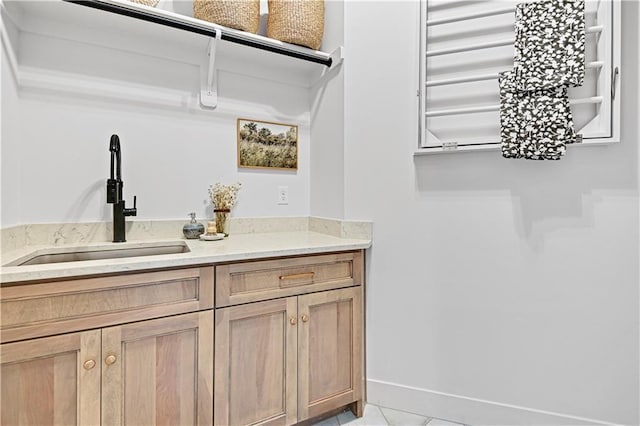 17004 Parkhill St, Overland Park, KS 66221 - laundry area featuring a sink and light tile patterned floors