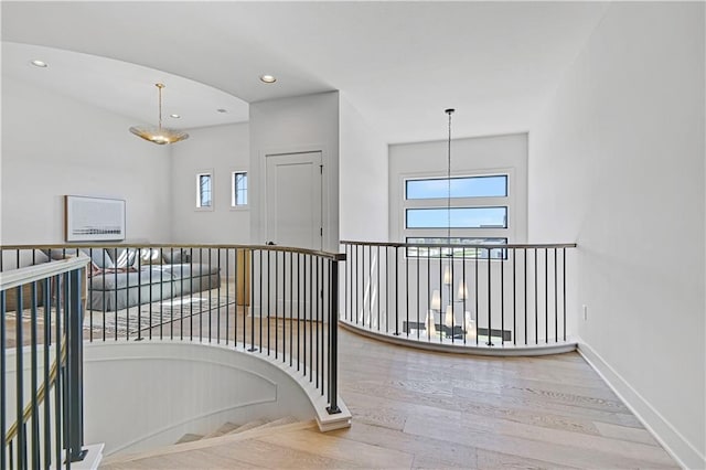 17004 Parkhill St, Overland Park, KS 66221 - hallway featuring plenty of natural light, an upstairs landing, wood finished floors, recessed lighting, and baseboards