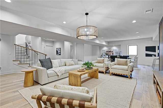 17004 Parkhill St, Overland Park, KS 66221 - living area with light wood-style floors, stairs, baseboards, and recessed lighting