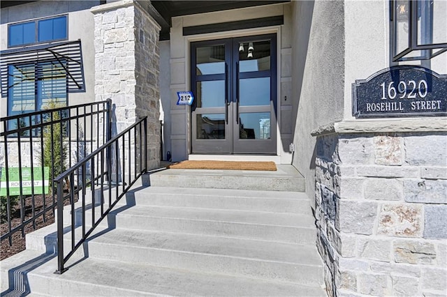 17004 Parkhill St, Overland Park, KS 66221 - property entrance featuring french doors, stone siding, and stucco siding