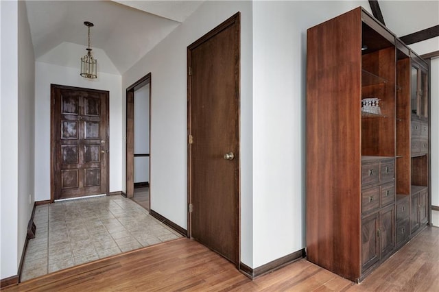 entrance foyer featuring vaulted ceiling and light hardwood / wood-style flooring