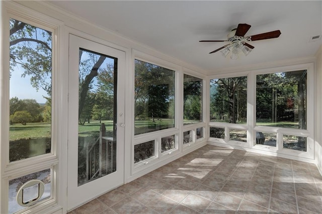 unfurnished sunroom featuring ceiling fan