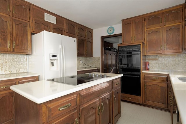 kitchen featuring decorative backsplash and black appliances