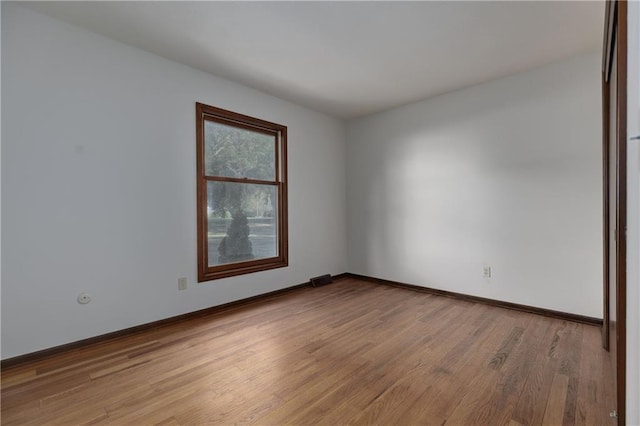 spare room with light wood-type flooring