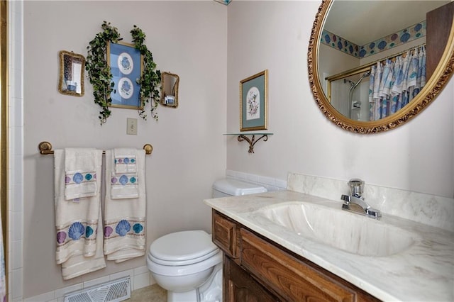 bathroom featuring a shower with curtain, vanity, tile patterned flooring, and toilet