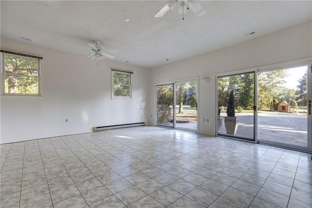 spare room with light tile patterned flooring, baseboard heating, a textured ceiling, and ceiling fan