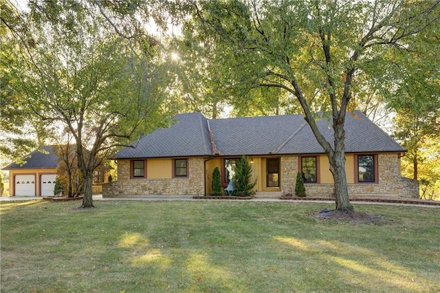 single story home with a garage and a front lawn