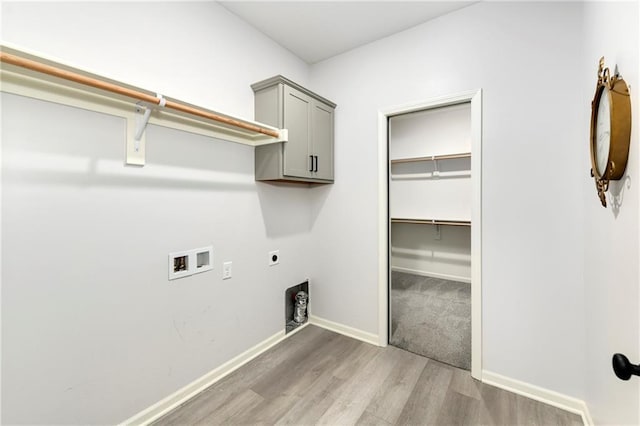 laundry area featuring electric dryer hookup, cabinets, wood-type flooring, and hookup for a washing machine