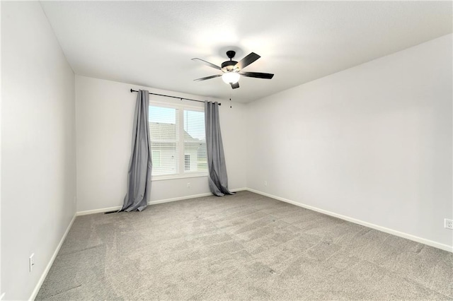 spare room featuring light carpet and ceiling fan