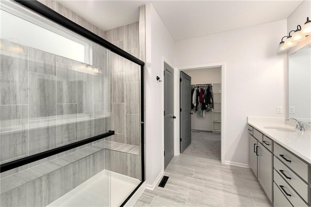 bathroom featuring vanity and a shower with door