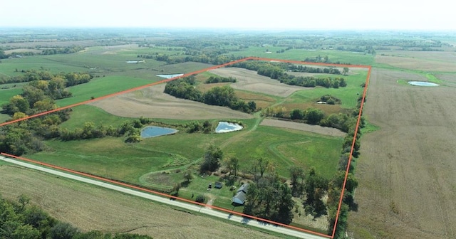 birds eye view of property featuring a water view and a rural view